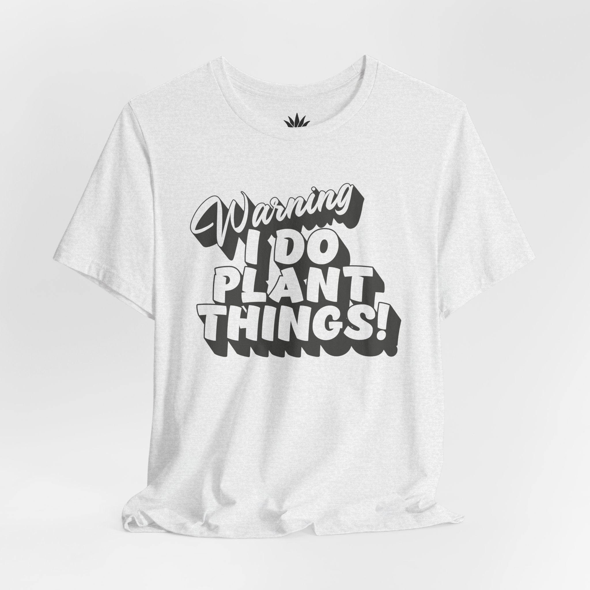 White t-shirt with black text 'Warning I Do Plant Things!' on a light gray background
