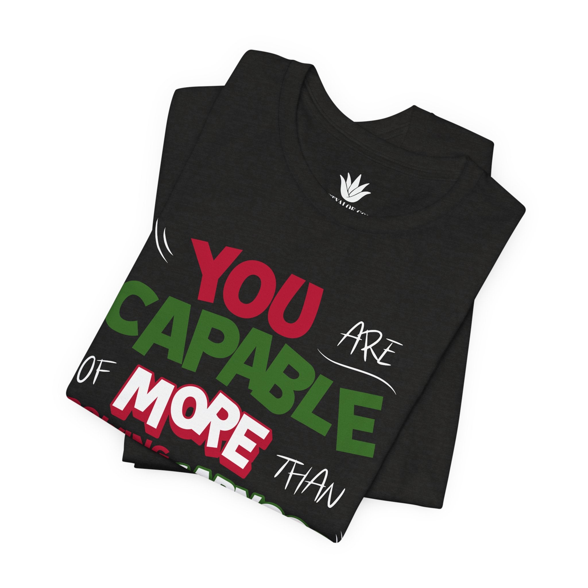 Black t-shirt with bold green, pink, and white “You are capable of more than growing carnosa” lettering for Hoya and plant lovers. Folded.