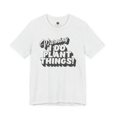 White t-shirt with black text 'Warning I Do Plant Things!' on a white background