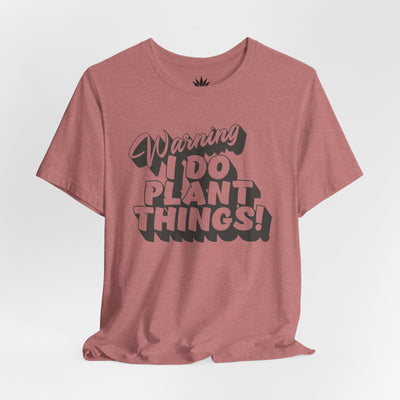 Pink t-shirt with text 'Warning I Do Plant Things!' on a white background