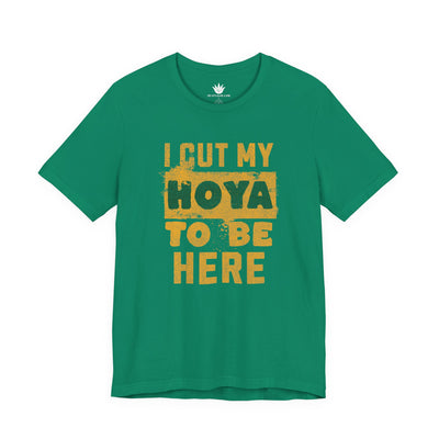 Green t-shirt with yellow text 'I cut my Hoya to be here' on a white background