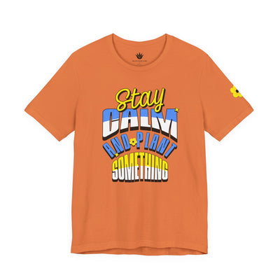 Orange t-shirt with colorful text design on a white background