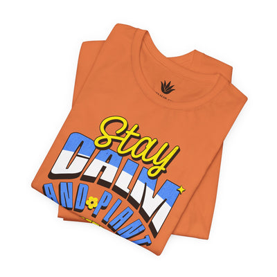 Orange t-shirt with colorful text design on a white background