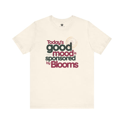 Beige t-shirt with text 'Today's good mood is sponsored by Blooms' on a white background