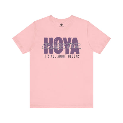 Pink t-shirt with 'HOYA' and 'It's All About Blooms' text on a white background
