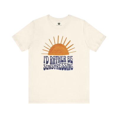 Beige t-shirt with a sun graphic and 'I'd Rather Be Sunstressing' text on a white background