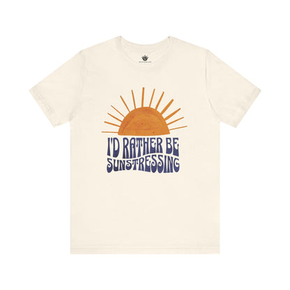 Beige t-shirt with a sun graphic and 'I'd Rather Be Sunstressing' text on a white background