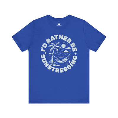 Blue t-shirt with white graphic and text 'I'd Rather Be Sunstressing' on a white background