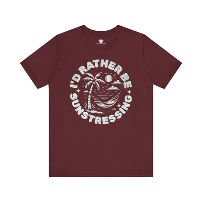 Maroon t-shirt with 'I'd Rather Be Sunstressing' graphic on a white background