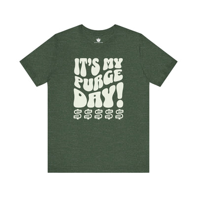 Green t-shirt with white text 'It's my purge day! $$$$$' on a white background