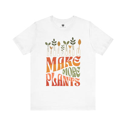 White t-shirt with 'MAKE MORE PLANTS' text and plant graphics on a white background