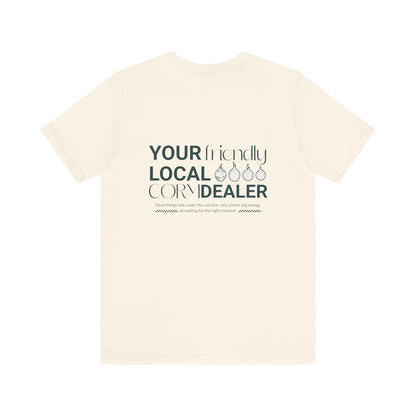Beige t-shirt with text 'Your Friendly Local Corn Dealer' on a white background