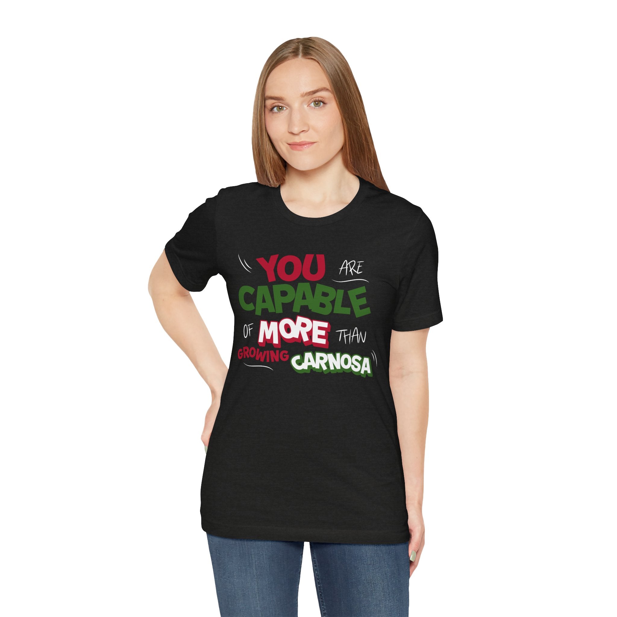 Black t-shirt with bold green, pink, and white “You are capable of more than growing carnosa” lettering for Hoya and plant lovers. Wman model.
