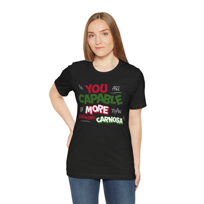 Black t-shirt with bold green, pink, and white “You are capable of more than growing carnosa” lettering for Hoya and plant lovers. Wman model.